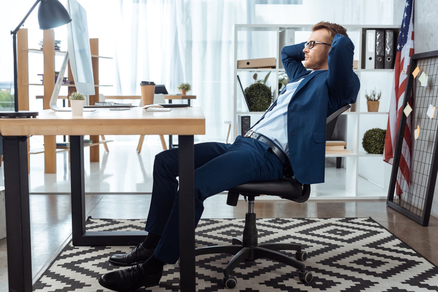 man relaxing on office chairs